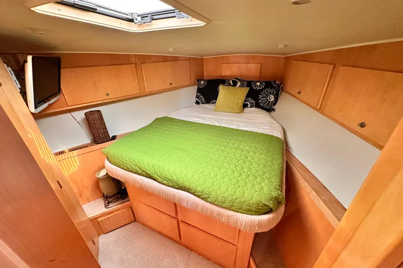Barkruiser Yacht Photos Pics Cozy cabin interior of 1998 Navigator 4800 yacht with bed and storage.