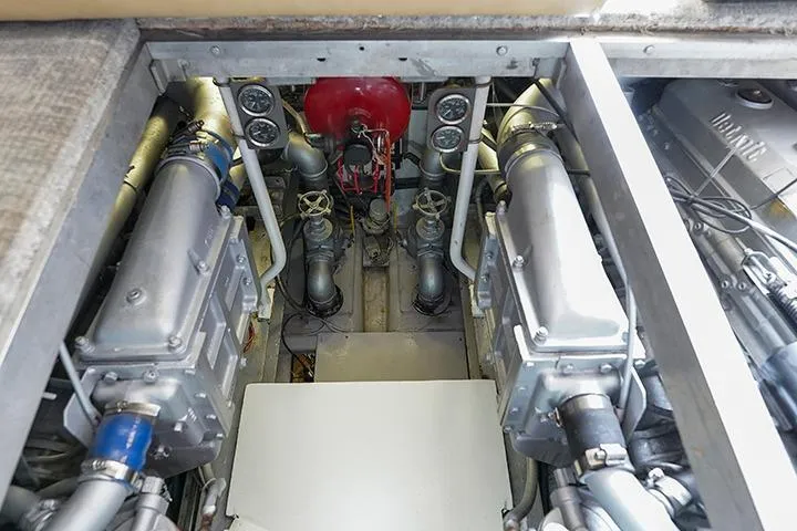 Impulse Yacht Photos Pics Engine room of a 1987 Viking Palm Beach boat, showcasing mechanical components and gauges.