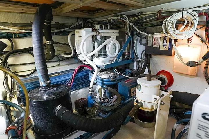 Impulse Yacht Photos Pics Engine room of 1987 Viking Palm Beach boat with complex wiring and machinery.