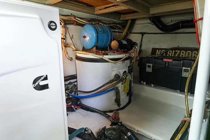 Impulse Yacht Photos Pics Engine room of a 1987 Viking Palm Beach boat, featuring Cummins equipment and various components.