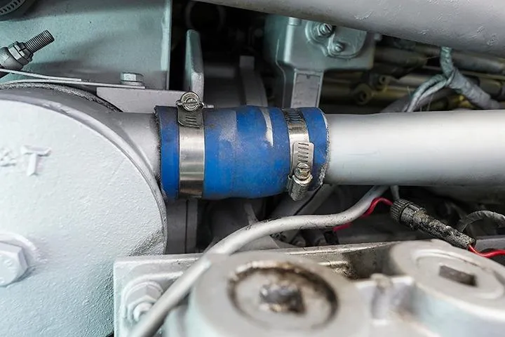 Impulse Yacht Photos Pics Engine components of a 1987 Viking Palm Beach boat, featuring hoses and clamps.