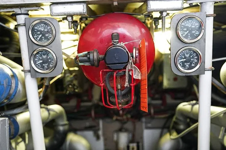 Impulse Yacht Photos Pics Engine room of 1987 Viking Palm Beach boat with gauges and red fire extinguisher.