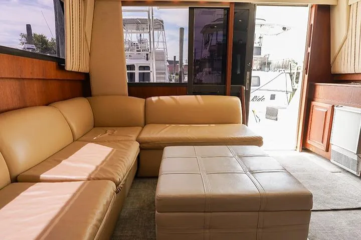 Impulse Yacht Photos Pics 1987 Viking Palm Beach yacht interior with beige leather seating and large windows.