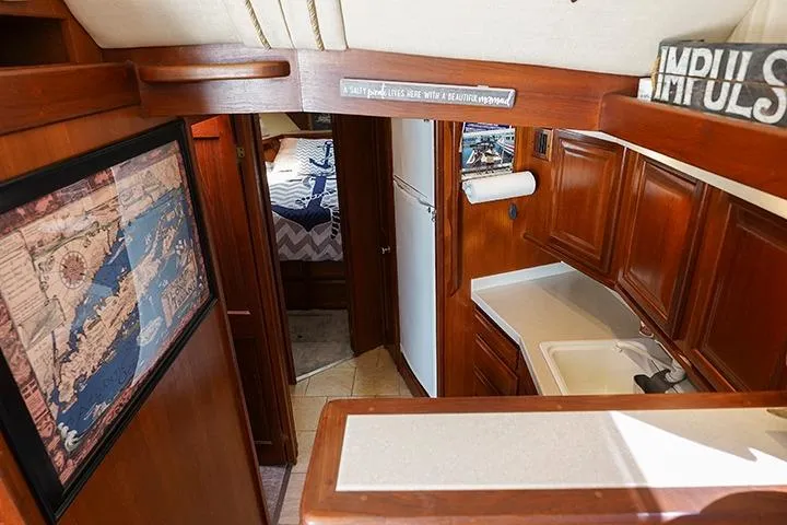 Impulse Yacht Photos Pics Interior of a 1987 Viking Palm Beach boat with wood cabinetry and nautical decor.
