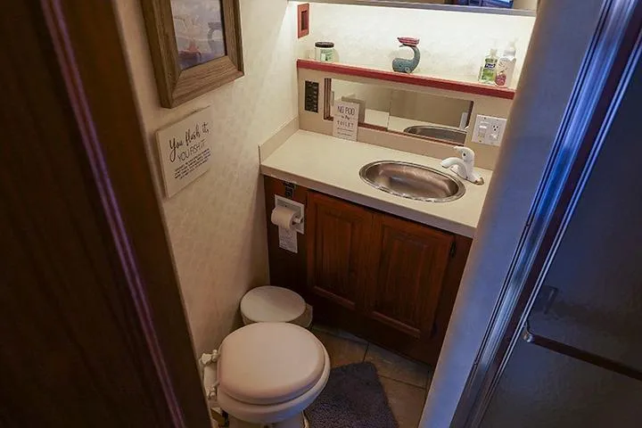 Impulse Yacht Photos Pics Compact bathroom in a 1987 Viking Palm Beach, featuring a sink and toilet.