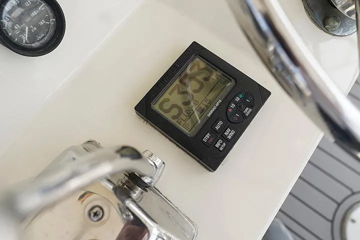 Impulse Yacht Photos Pics Close-up of 1987 Viking Palm Beach boat dashboard with digital display and controls.