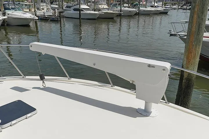 Impulse Yacht Photos Pics 1987 Viking Palm Beach yacht deck with davit, docked in marina.