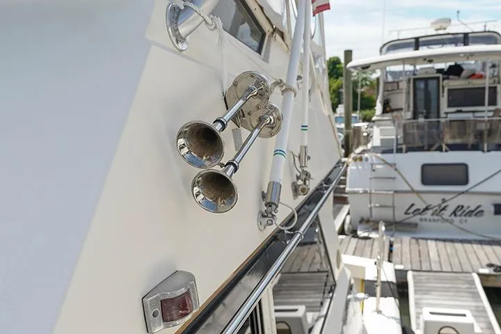Impulse Yacht Photos Pics 1987 Viking Palm Beach yacht with chrome horns docked at marina.