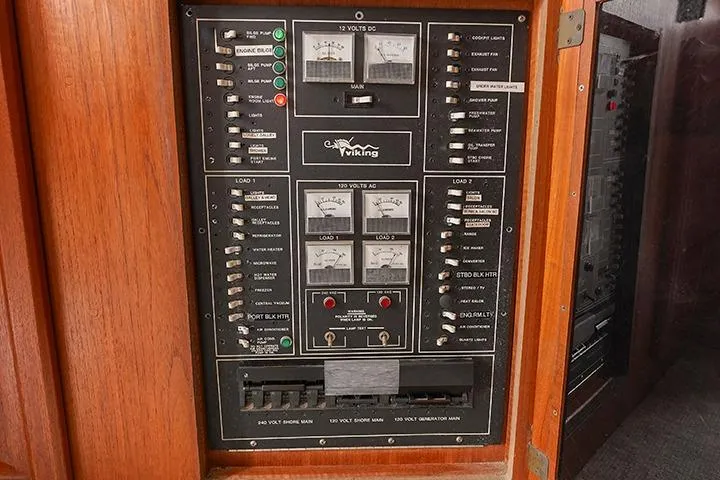 Impulse Yacht Photos Pics Electrical control panel of a 1987 Viking Palm Beach boat, featuring various switches and meters.