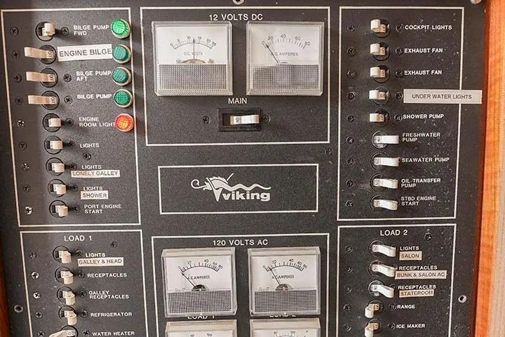 Impulse Yacht Photos Pics 1987 Viking Palm Beach control panel with switches and gauges for electrical systems.