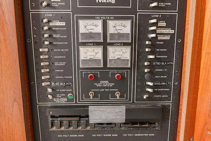 Impulse Yacht Photos Pics Control panel of a 1987 Viking Palm Beach boat, featuring various switches and voltage meters.
