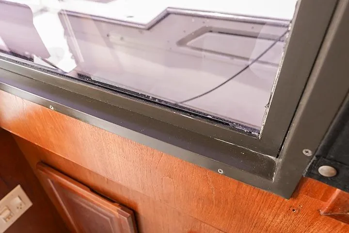 Impulse Yacht Photos Pics 1987 Viking Palm Beach boat interior, showcasing wooden paneling and window details.