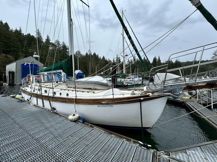  Yacht Photos Pics Sailboat docked at marina, Custom Seawing-Atkins 2002 model, overcast sky, forested background.