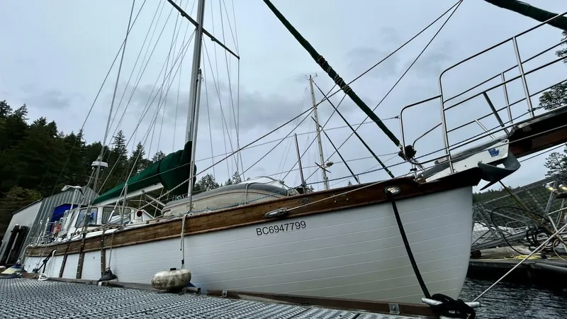  Yacht Photos Pics Sailboat docked at marina, Custom Seawing-Atkins model, 2002, with forested background.
