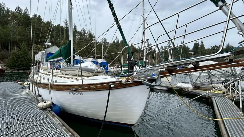  Yacht Photos Pics Custom Seawing-Atkins 2002 sailboat docked in a serene marina setting.