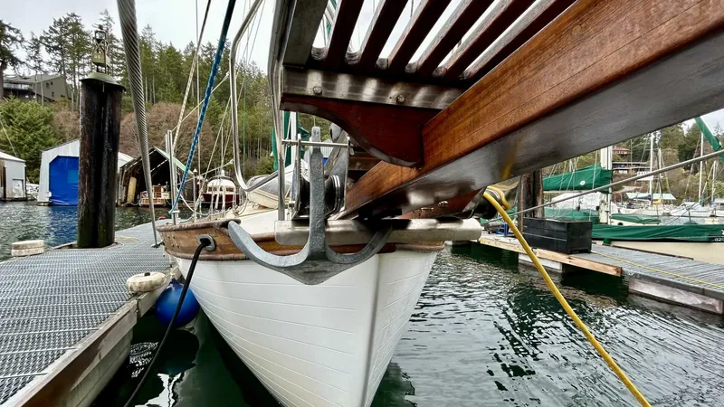  Yacht Photos Pics Custom Seawing-Atkins 2002 boat docked at marina, featuring wooden bow and anchor.