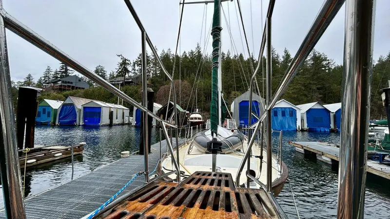  Yacht Photos Pics Sailboat docked at marina with colorful boathouses, Custom Seawing-Atkins, 2002 model.