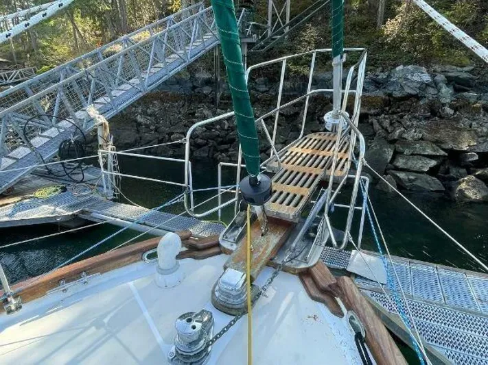  Yacht Photos Pics Bow of 2002 Custom Seawing-Atkins boat docked near rocky shoreline.