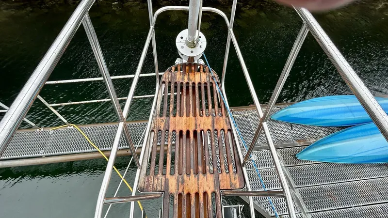  Yacht Photos Pics Wooden boat deck with metal railings, overlooking water and blue kayaks. Custom Seawing-Atkins, 2002.