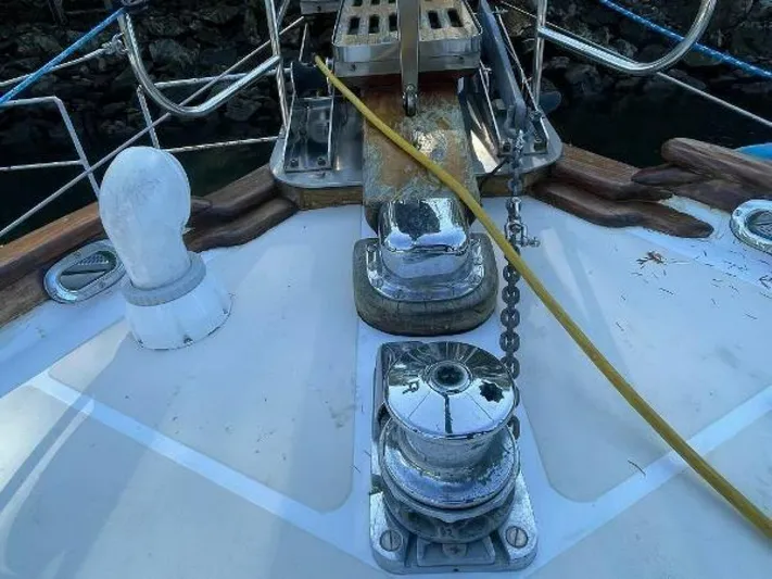  Yacht Photos Pics Deck of 2002 Custom Seawing-Atkins boat with winches and chain, docked by rocky shore.