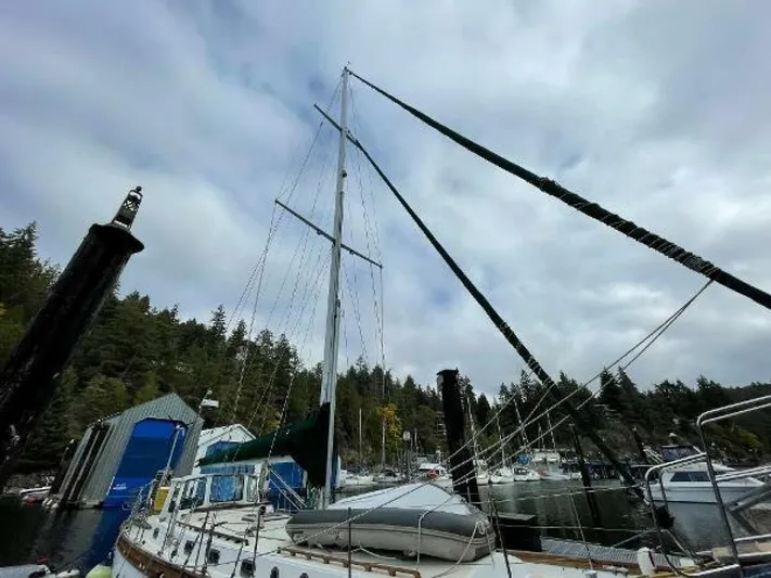  Yacht Photos Pics Sailboat docked in marina, Custom Seawing-Atkins 2002, surrounded by trees and cloudy sky.