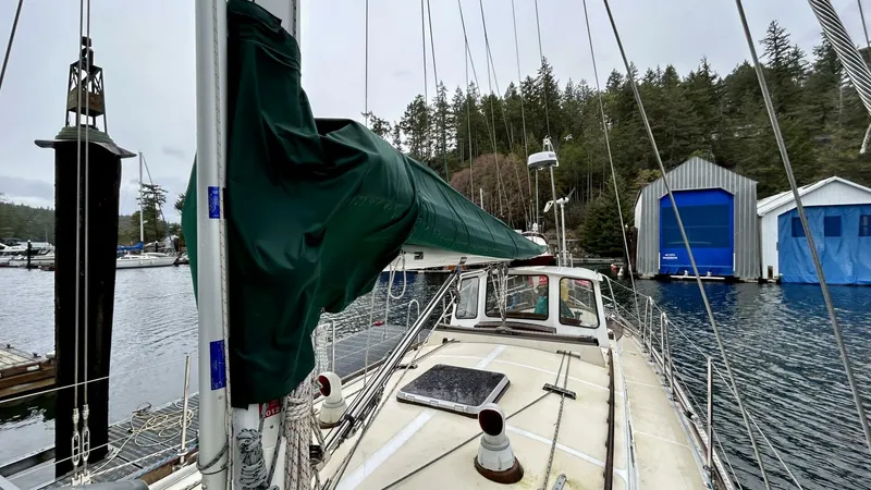  Yacht Photos Pics Sailboat docked in marina, Custom Seawing-Atkins 2002, surrounded by forested landscape.