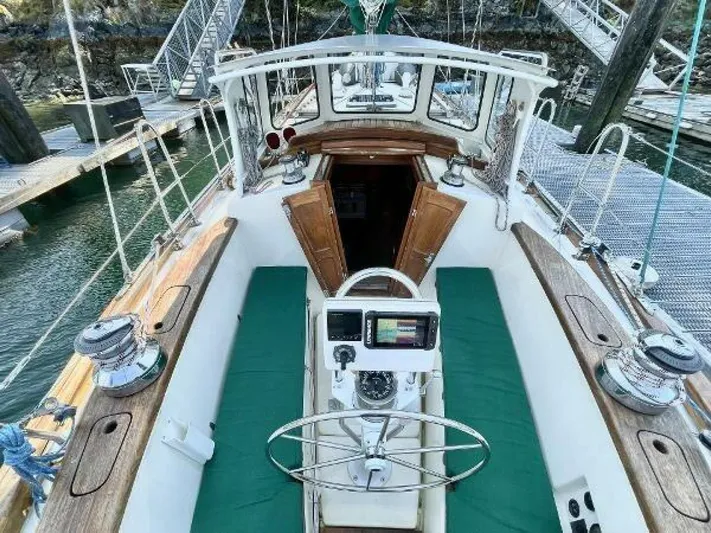  Yacht Photos Pics Cockpit view of 2002 Custom Seawing-Atkins sailboat with green seating and wooden accents.