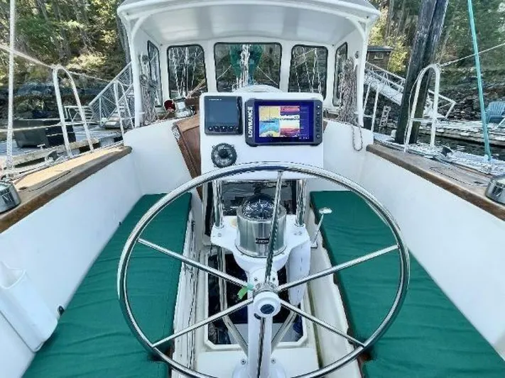 Yacht Photos Pics Cockpit of 2002 Custom Seawing-Atkins boat with steering wheel and navigation system.