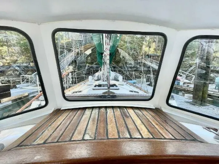  Yacht Photos Pics Interior view of 2002 Custom Seawing-Atkins boat with wooden deck and marina background.