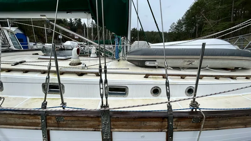  Yacht Photos Pics Sailboat deck with rigging, featuring a Custom Seawing-Atkins model from 2002, docked near forested shoreline.