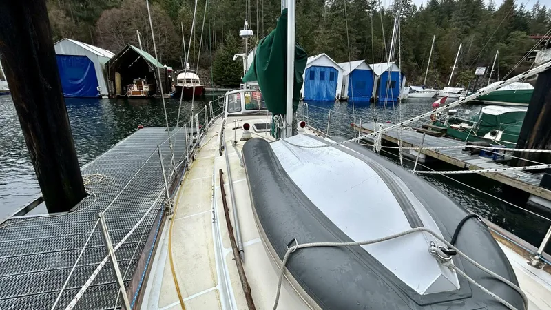  Yacht Photos Pics Custom Seawing-Atkins 2002 sailboat docked at marina with covered boats in background.