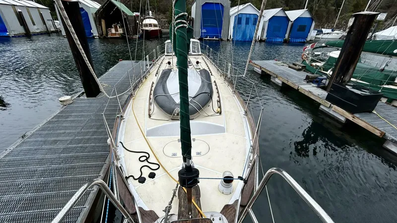  Yacht Photos Pics Sailboat docked at marina, Custom Seawing-Atkins 2002, surrounded by covered slips.