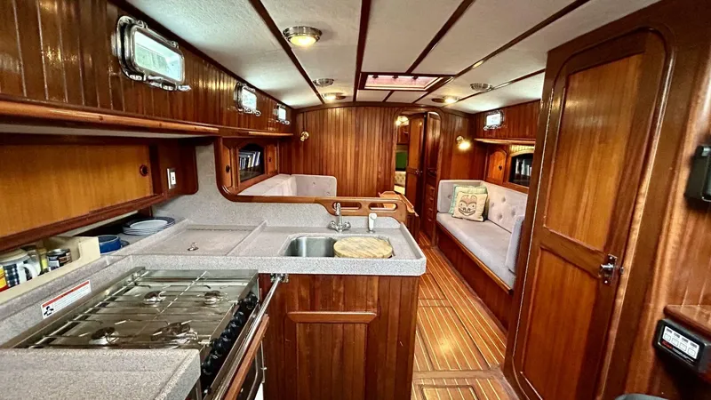  Yacht Photos Pics Luxurious 2002 Custom Seawing-Atkins yacht interior with wood paneling and modern kitchen amenities.