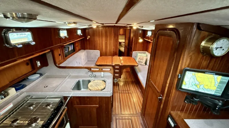  Yacht Photos Pics Luxurious 2002 Custom Seawing-Atkins yacht interior with kitchen, dining area, and navigation equipment.