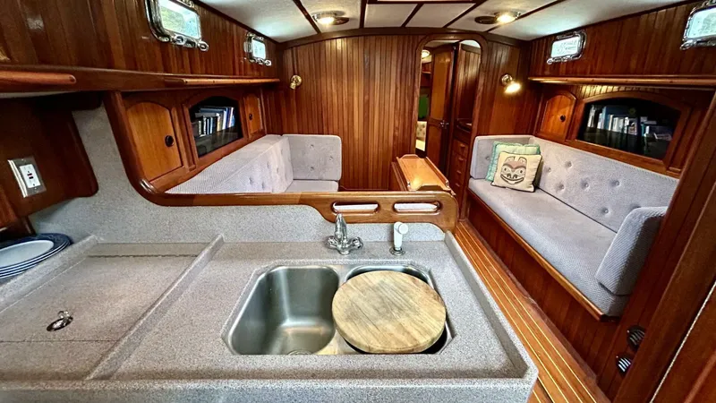  Yacht Photos Pics Interior of 2002 Custom Seawing-Atkins boat with wooden paneling and cozy seating area.