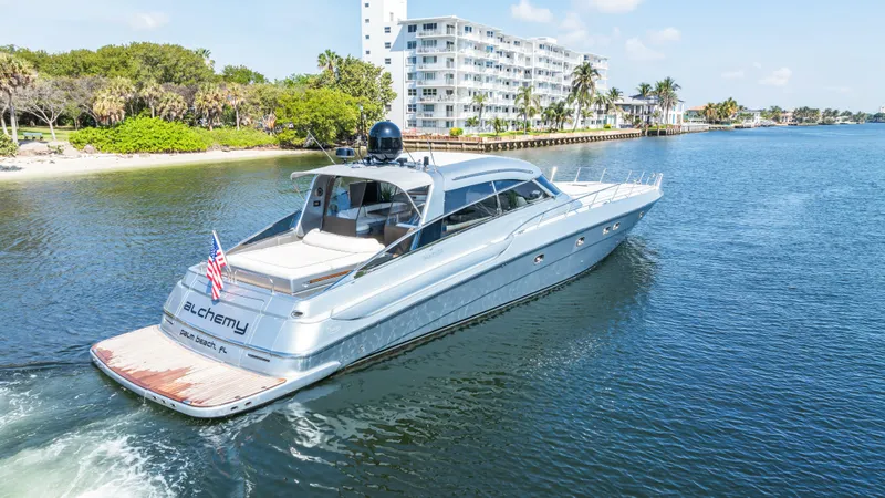 Alchemy Yacht Photos Pics Luxury 2003 Baia Panther 80 yacht cruising on a scenic waterway.