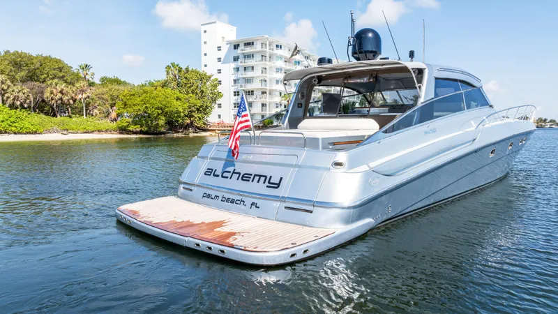 Alchemy Yacht Photos Pics Luxury 2003 Baia Panther 80 yacht on water, with American flag and modern design.