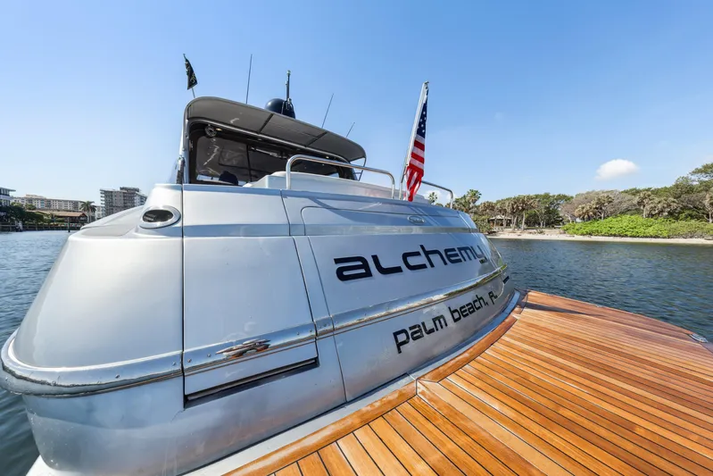 Alchemy Yacht Photos Pics 2003 Baia PANTHER 80 yacht docked, featuring sleek design and American flag.