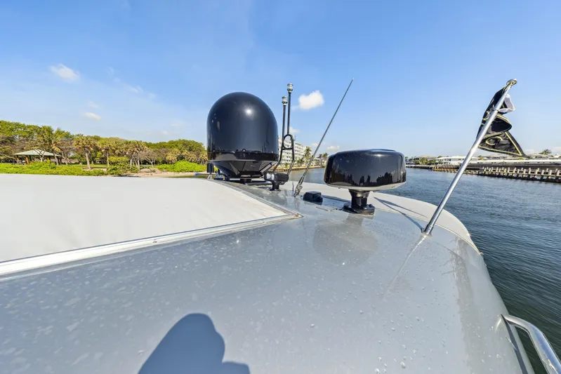 Alchemy Yacht Photos Pics 2003 Baia PANTHER 80 yacht deck with radar and antennas under clear blue sky.