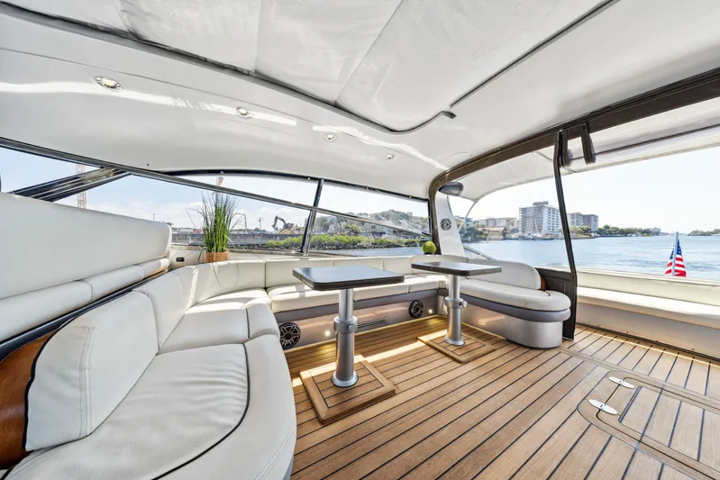 Alchemy Yacht Photos Pics Luxurious 2003 Baia Panther 80 yacht interior with elegant seating and scenic water views.