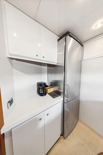 Alchemy Yacht Photos Pics Compact kitchen area in a 2003 Baia PANTHER 80 yacht with modern appliances.
