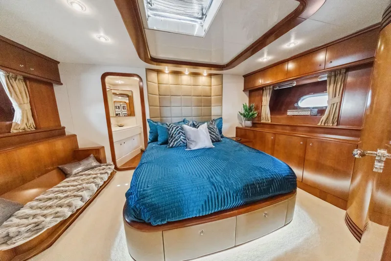 Alchemy Yacht Photos Pics Luxurious cabin interior of 2003 Baia Panther 80 yacht with elegant wood finishes.