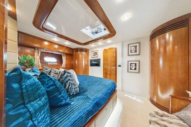 Alchemy Yacht Photos Pics Luxurious cabin interior of 2003 Baia PANTHER 80 yacht with elegant wood finishes.