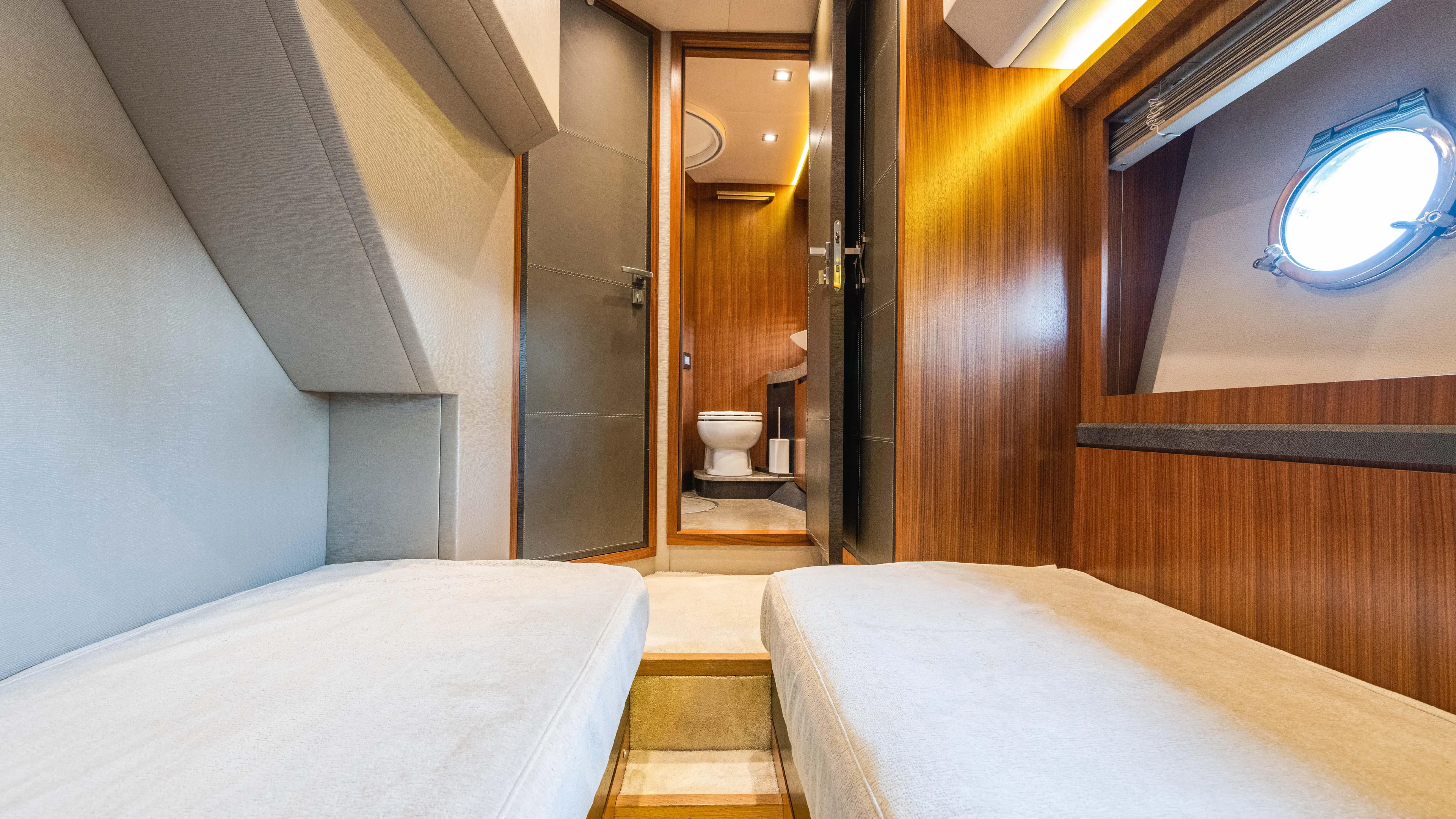 Nauti Style Yacht Photos Pics Luxurious interior of 2016 Monte Carlo Yachts MCY 65, featuring cozy cabin and modern bathroom.