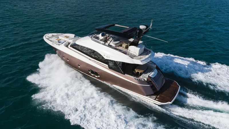 Nauti Style Yacht Photos Pics 2016 Monte Carlo Yachts MCY 65 cruising on open water, showcasing luxury and performance.