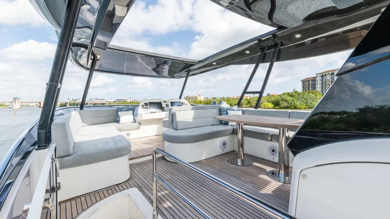Nauti Style Yacht Photos Pics Luxurious 2016 Monte Carlo Yachts MCY 65 deck with elegant seating and scenic views.