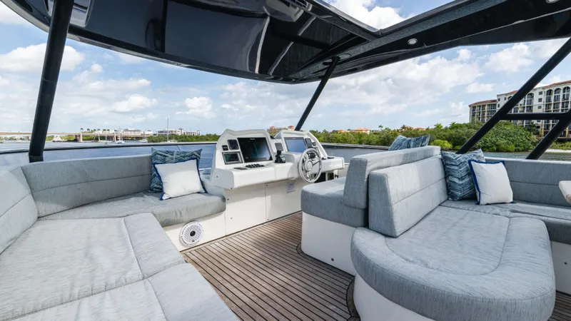 Nauti Style Yacht Photos Pics Luxurious 2016 Monte Carlo Yachts MCY 65 interior with plush seating and modern helm.