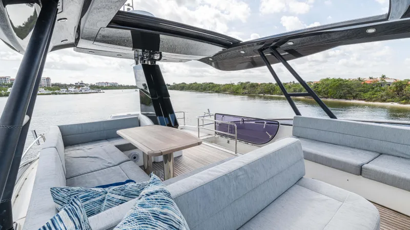 Nauti Style Yacht Photos Pics Luxurious 2016 Monte Carlo Yachts MCY 65 deck with elegant seating and scenic water view.