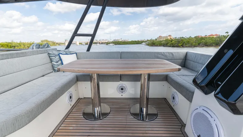 Nauti Style Yacht Photos Pics Luxurious 2016 Monte Carlo Yachts MCY 65 deck with elegant seating and wooden table.