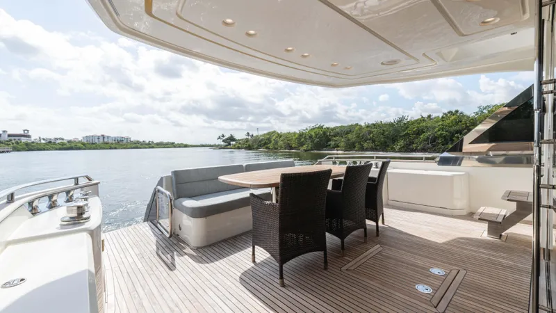 Nauti Style Yacht Photos Pics Luxurious 2016 Monte Carlo Yachts MCY 65 deck with elegant seating and scenic water view.